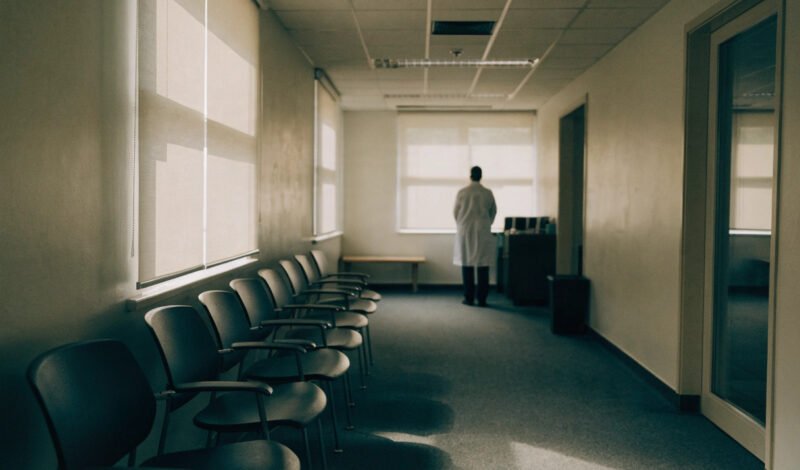 a gp partner alone in a surgery building illustrating the last man standing risk in practice ownership