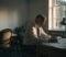 gp partner reviewing practice paperwork alone in a surgery office gp partner reviewing practice paperwork alone in a surgery office