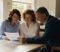 gp partners reviewing a partnership agreement together in a surgery meeting room gp partners reviewing a partnership agreement together in a surgery meeting room