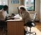 gp practice manager and partner reviewing an nhs gp contract in a surgery office gp practice manager and partner reviewing an nhs gp contract in a surgery office