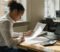 gp practice manager reviewing an nhs overpayment recovery letter at a practice office des gp practice manager reviewing an nhs overpayment recovery letter at a practice office desk