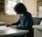 Dental practice director reviewing nominated individual responsibilities and compliance paperwork