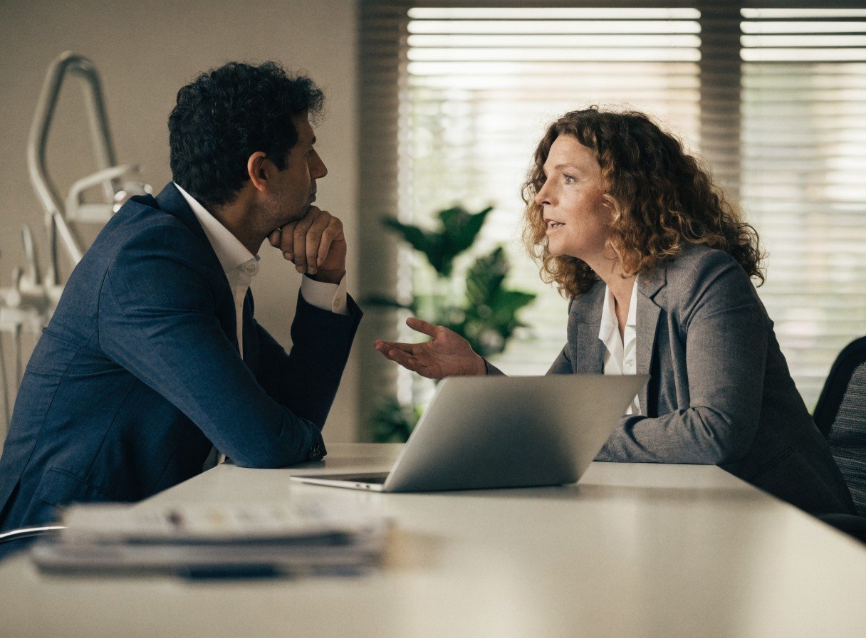 Dental practice director discussing nominated individual application requirements with an adviser