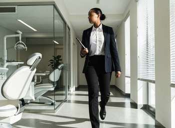 Registered manager checking compliance records during a walkthrough of a dental practice