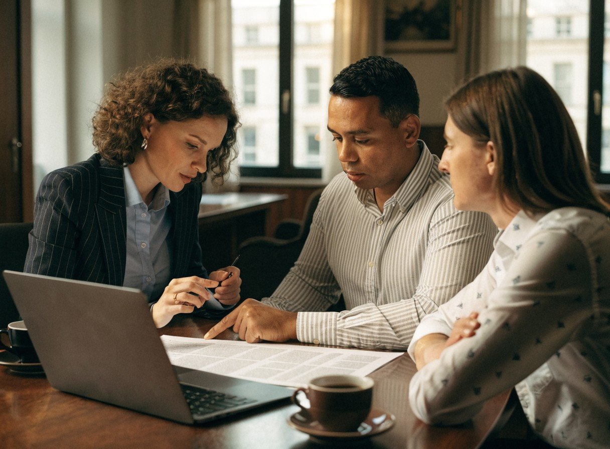 A solicitor explaining partnership agreement clauses to two dental practice partners in a meeting