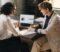 dental practice owner reviewing a valuation report with an adviser Dental practice owner reviewing a valuation report with an adviser