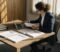 dentist regulation overview for practice owners Dental practice owner reviewing regulatory compliance documents at a desk
