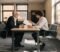 Two people reviewing a dental partnership agreement document at a solicitor's office table