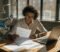 Dental practice owner reviewing a letter and financial figures at a desk