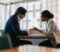 unfair dismissal solicitors client meeting Solicitor meeting with a client to discuss an unfair dismissal case in a London office