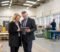 two business owners reviewing asset purchase documents with a solicitor in a small london commercial unit Two business owners reviewing asset purchase documents with a solicitor in a small London commercial unit