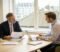 two business owners reviewing acquisition documents together in a london meeting room Two business owners reviewing acquisition documents together in a London meeting room