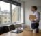 Business owner standing at a London office window considering the timetable for selling their company